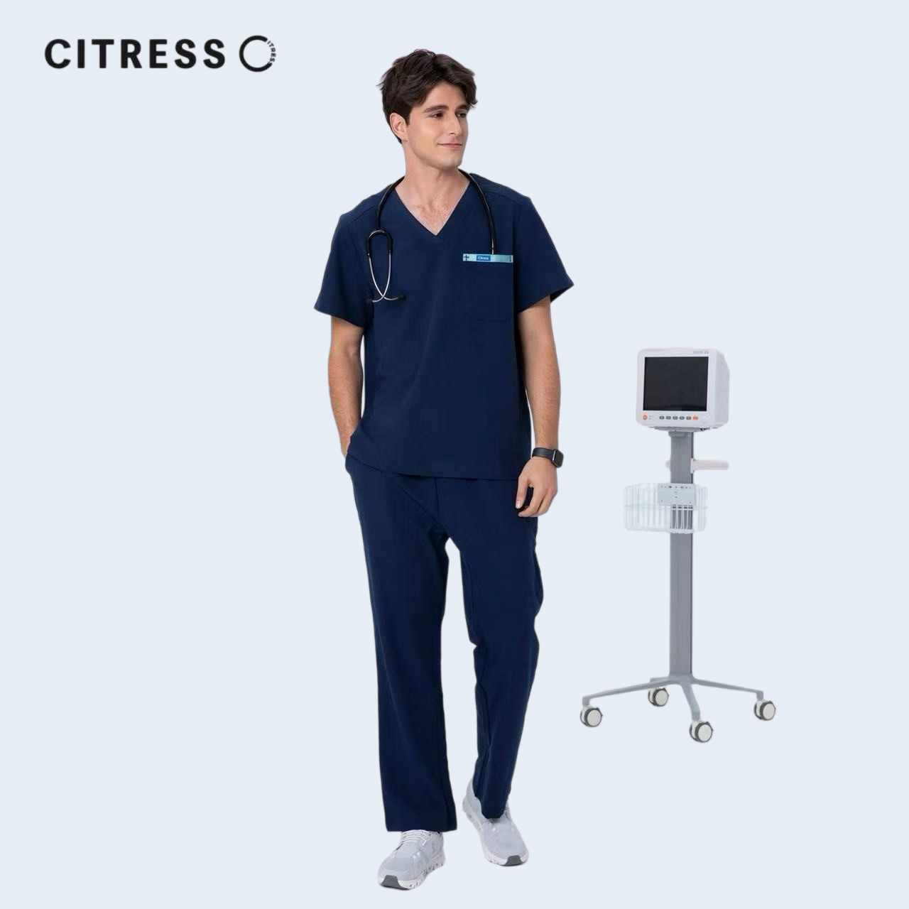 Male doctor wearing CITRESS navy scrub pants in hospital, professional medical workwear