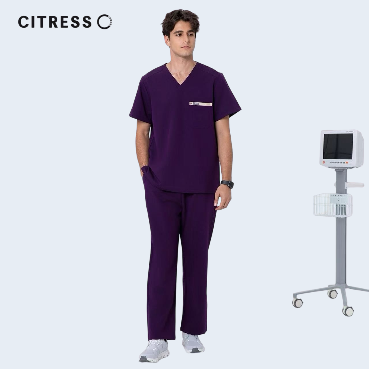Male doctor wearing CITRESS purple scrub pants in hospital, professional medical workwear