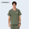 Front view of CITRESS green scrub top, showing V-neck and chest pocket