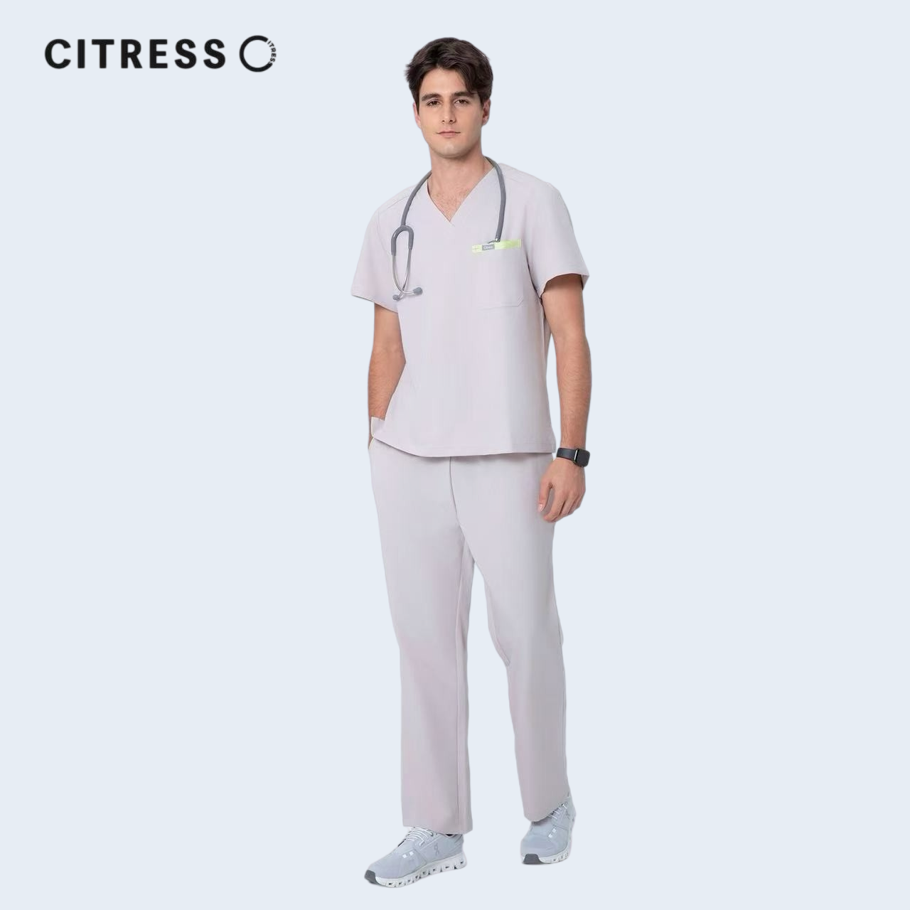 Male doctor wearing CITRESS purple scrub set in hospital, professional medical workwear
