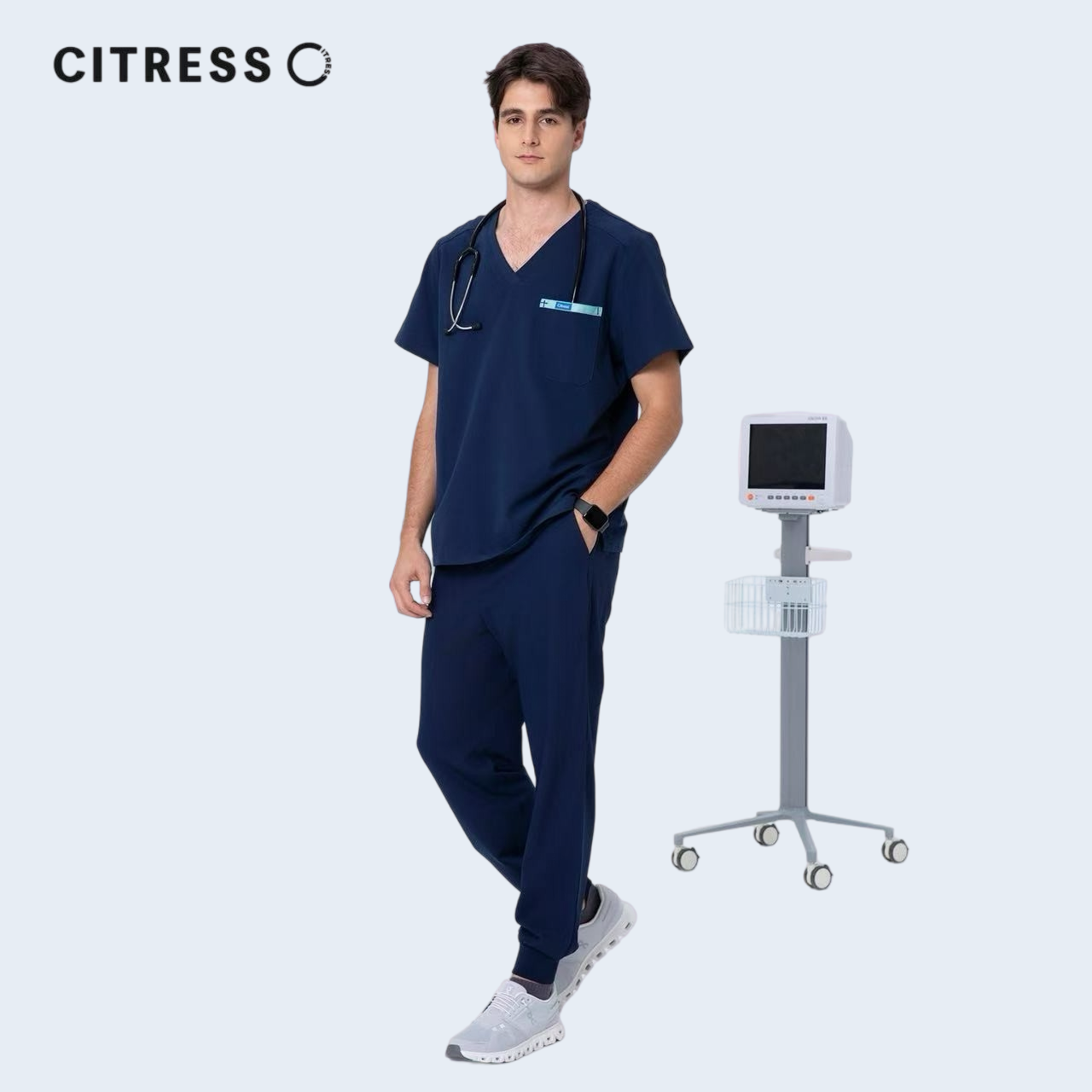 Male doctor wearing CITRESS navy scrub set in hospital, professional medical workwear