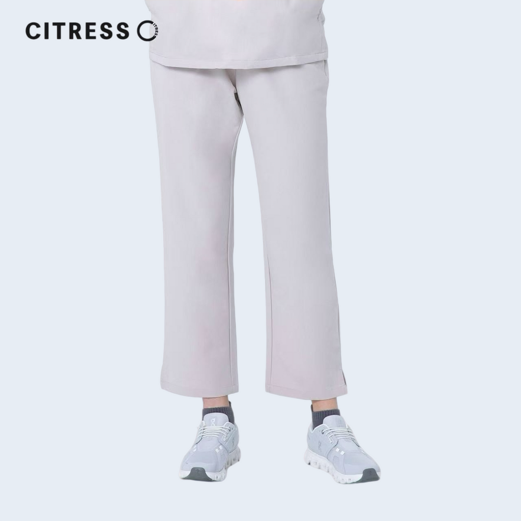Side view of CITRESS khaki scrub pants, showing straight leg fit and drawstring waist