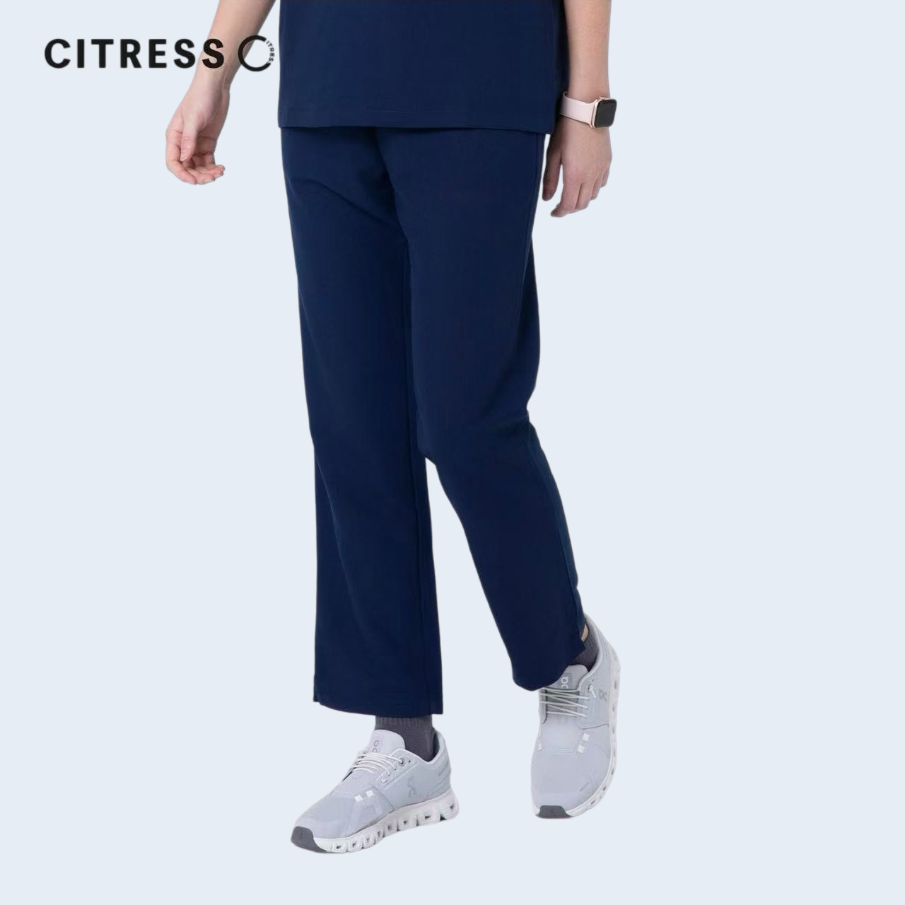 Side view of CITRESS navy scrub pants, showing straight leg fit and drawstring waist