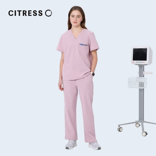 Nurse wearing CITRESS pink scrub pants in hospital, professional medical workwear