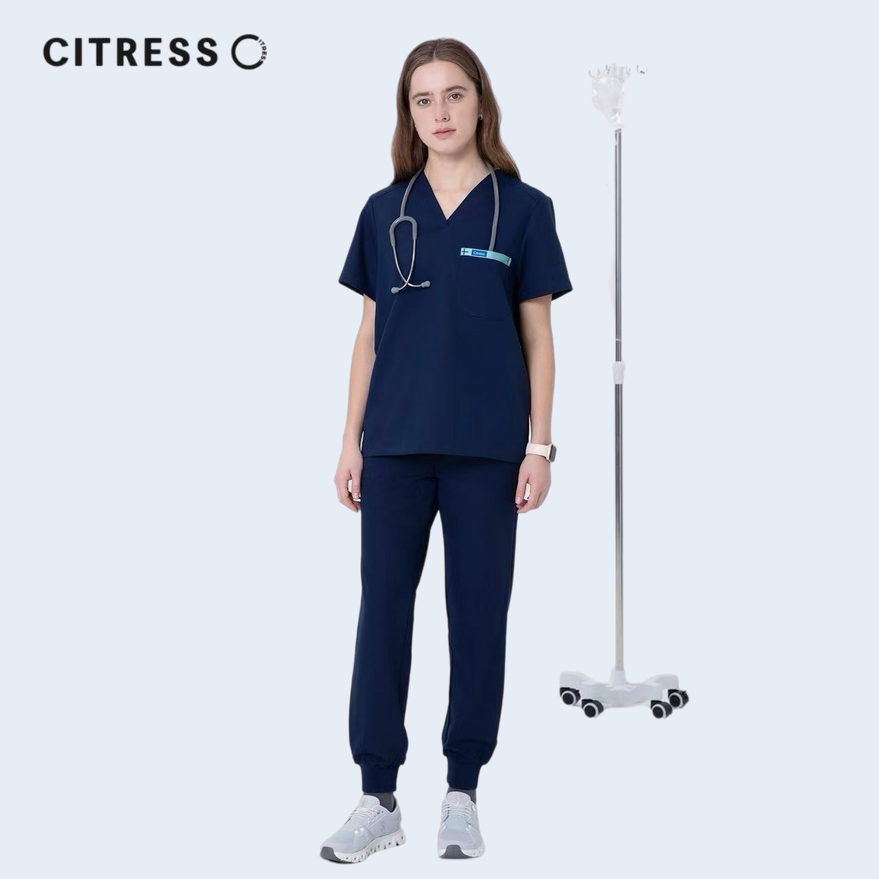 Nurse wearing CITRESS navy scrub set in hospital, professional medical workwear