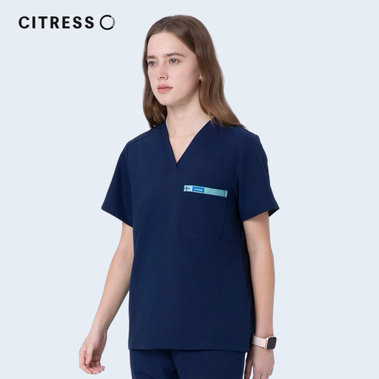 Front view of CITRESS navy scrub top, showing V-neck and chest pocket