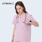 Close-up of CITRESS pink scrub top, showing V-neck and functional pocket