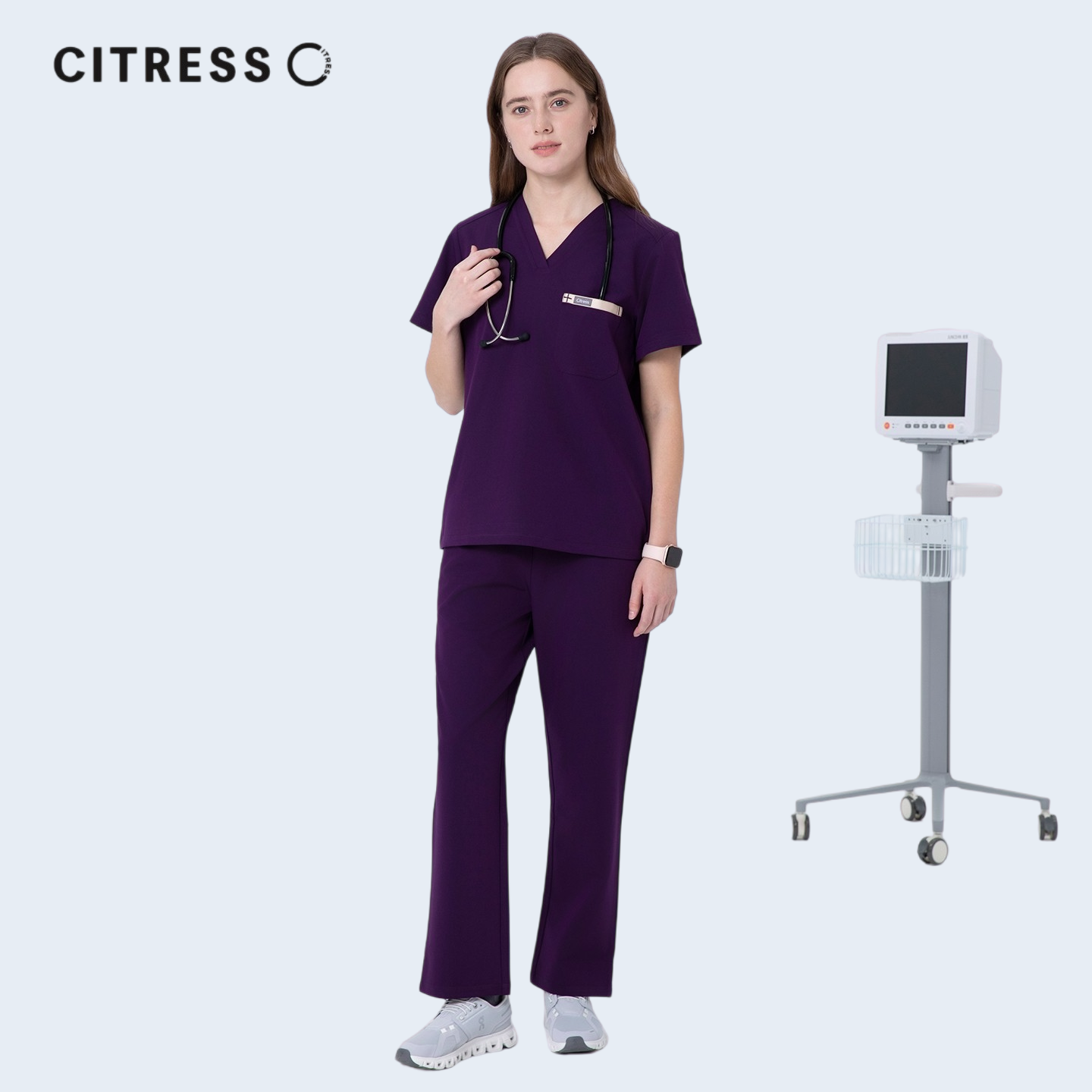 Nurse wearing CITRESS purple scrub set in hospital, professional medical workwear