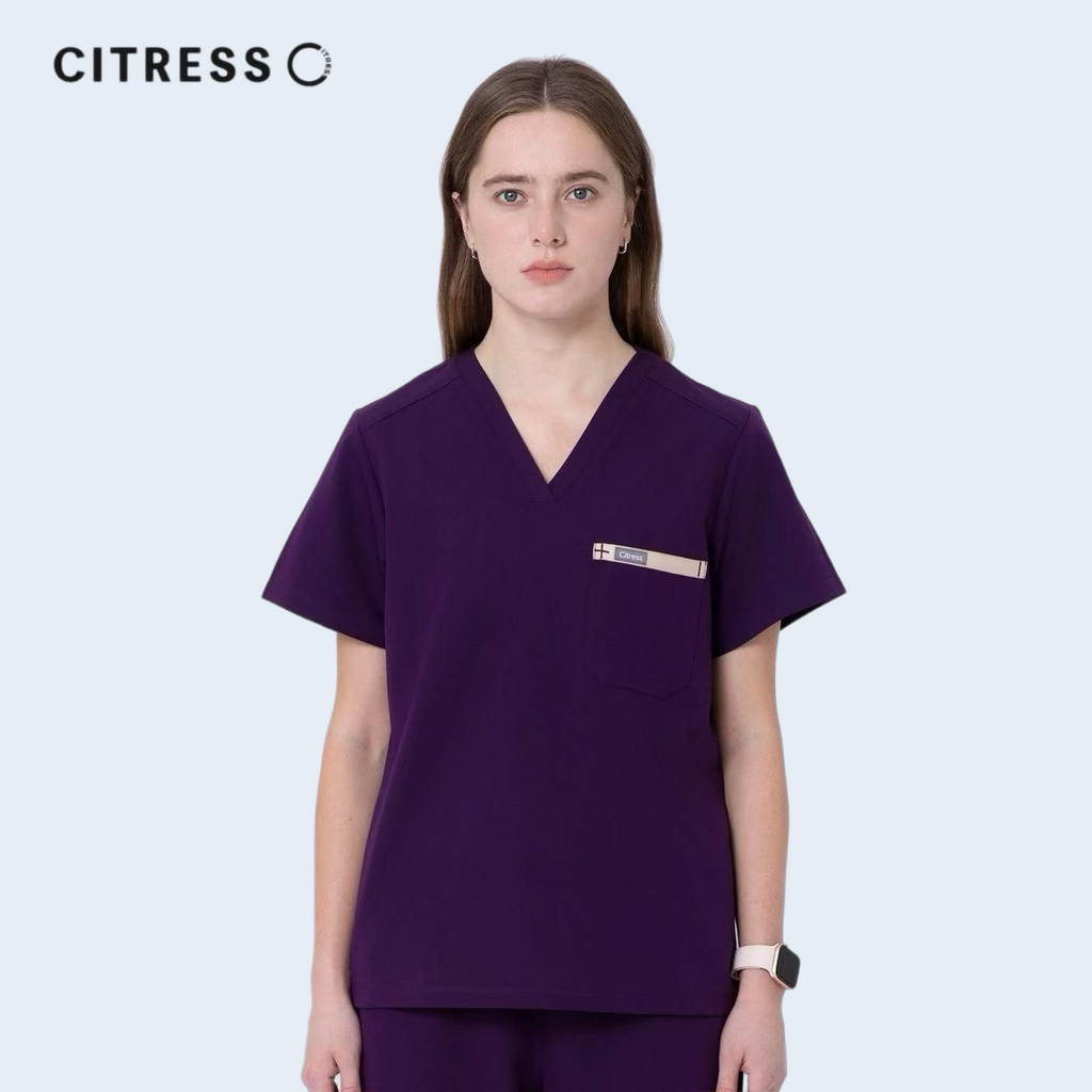 Front view of CITRESS purple scrub top, showing V-neck and chest pocket